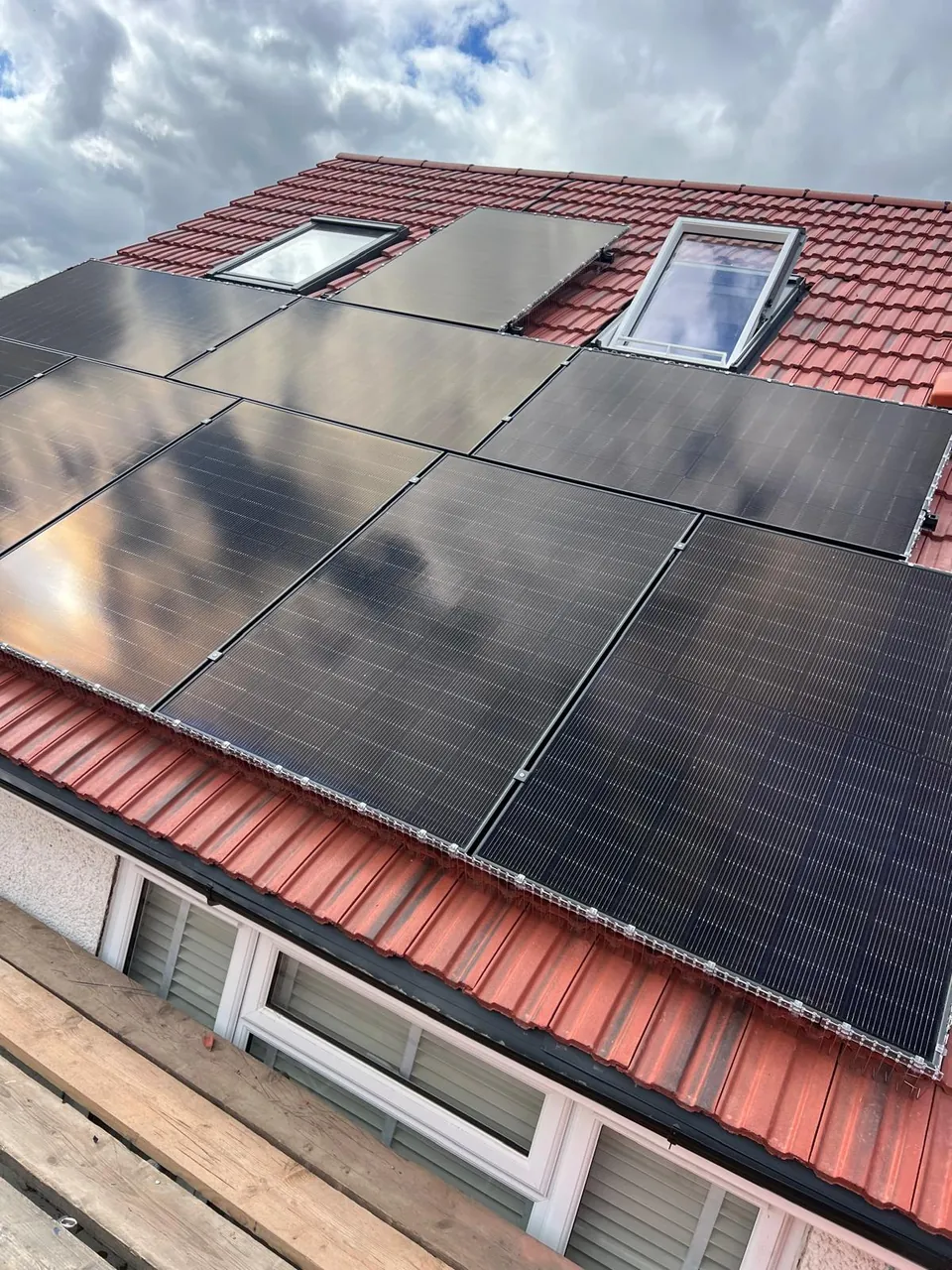 The pitched roof: panels laid out around the two roof windows.