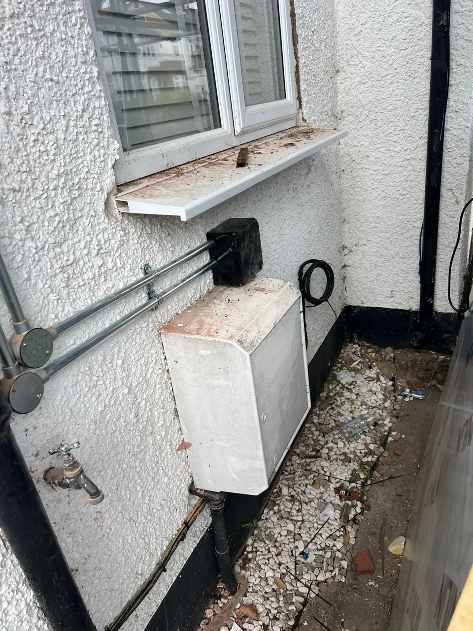 Galvanised conduit down the wall into the junction box.