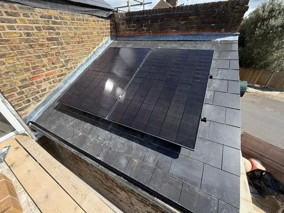 The panels on the slate roof of the single-storey extension.