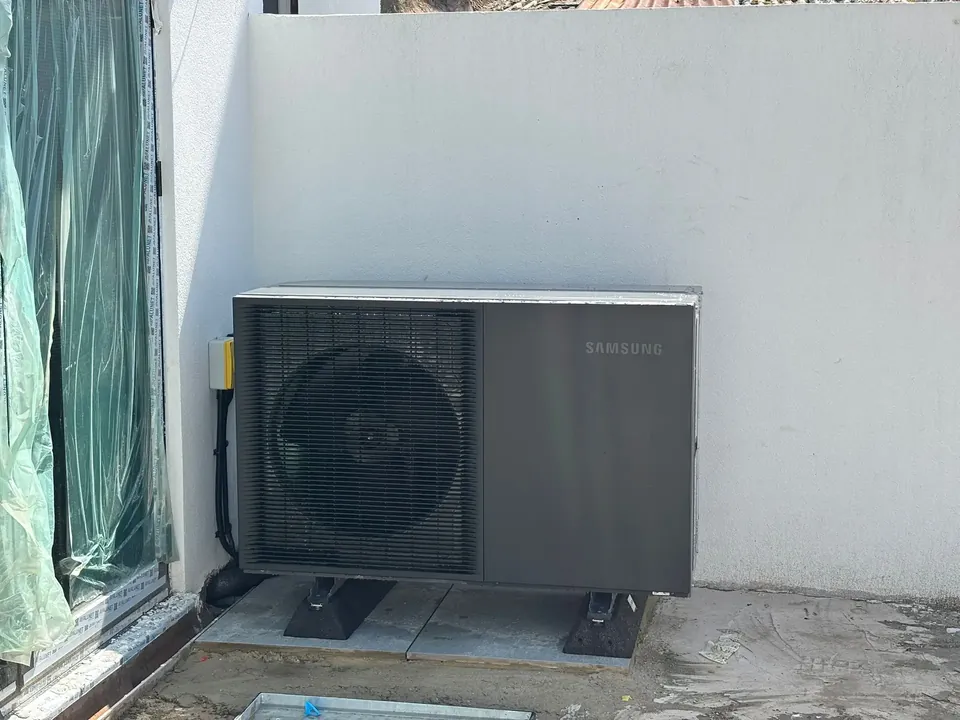 The Samsung unit tight against the side wall on anti-vibration feet.