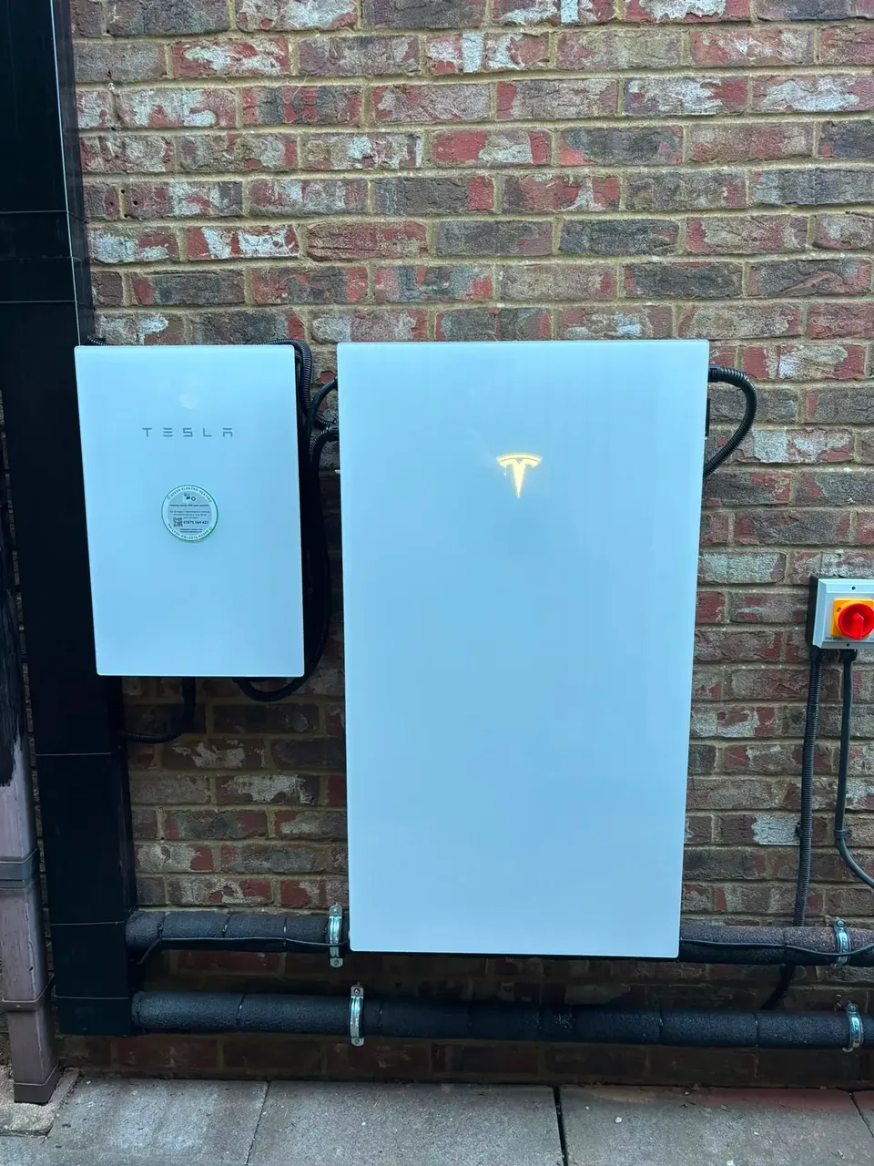 The Powerwall 3 and its gateway, with the cables in trunking below.