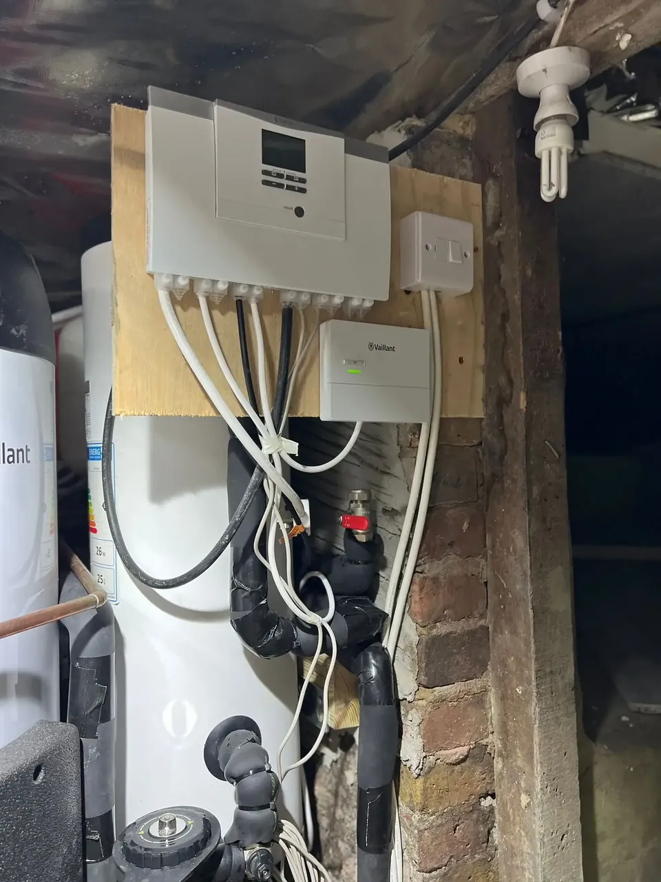The controls and wiring in the loft, fixed to a board on the wall.