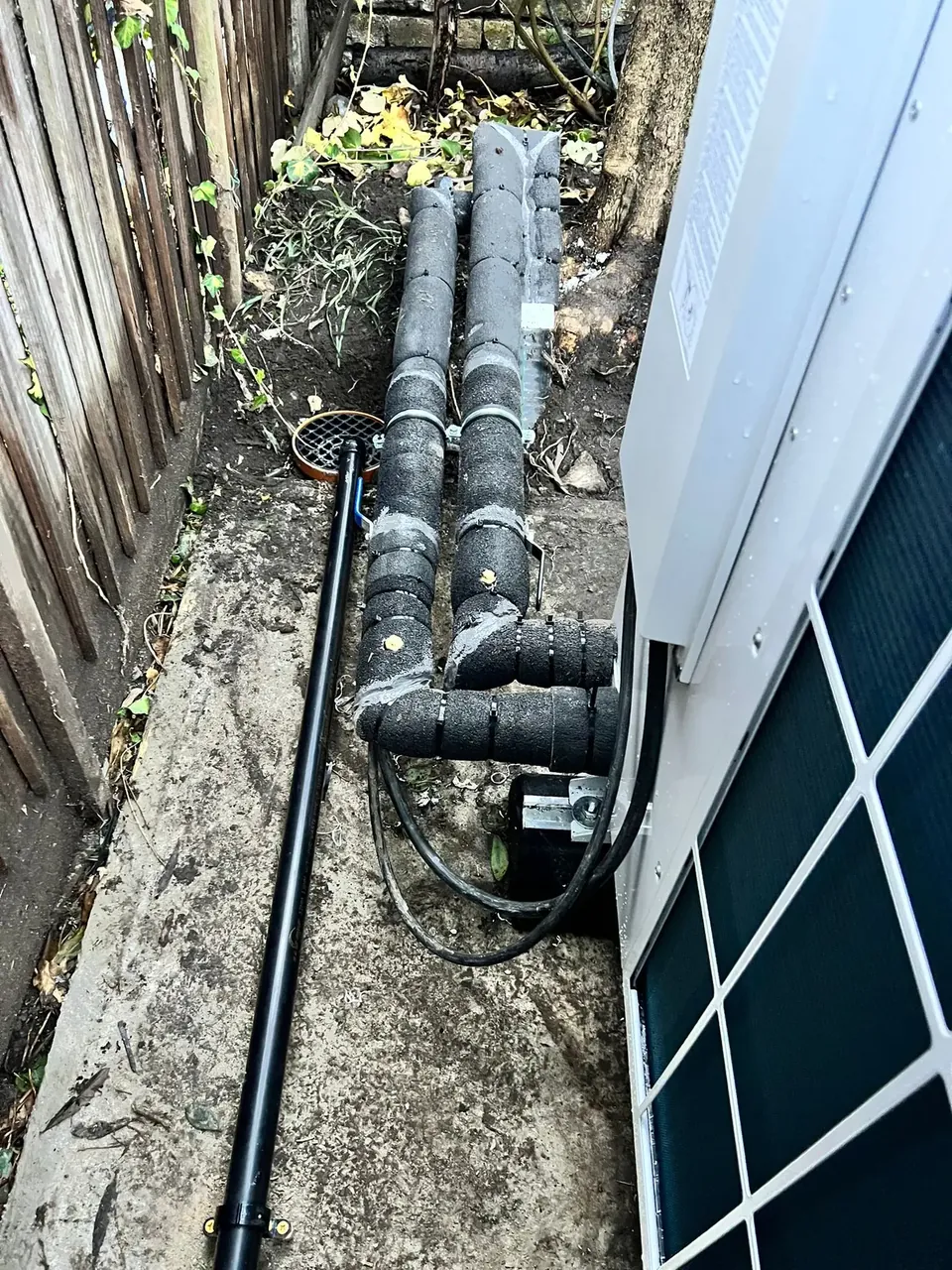 The flow and return running along the side of the house.
