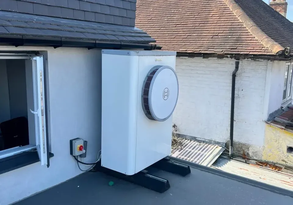 The Worcester Bosch unit on its raised frame on the flat roof, with the isolator beside it.