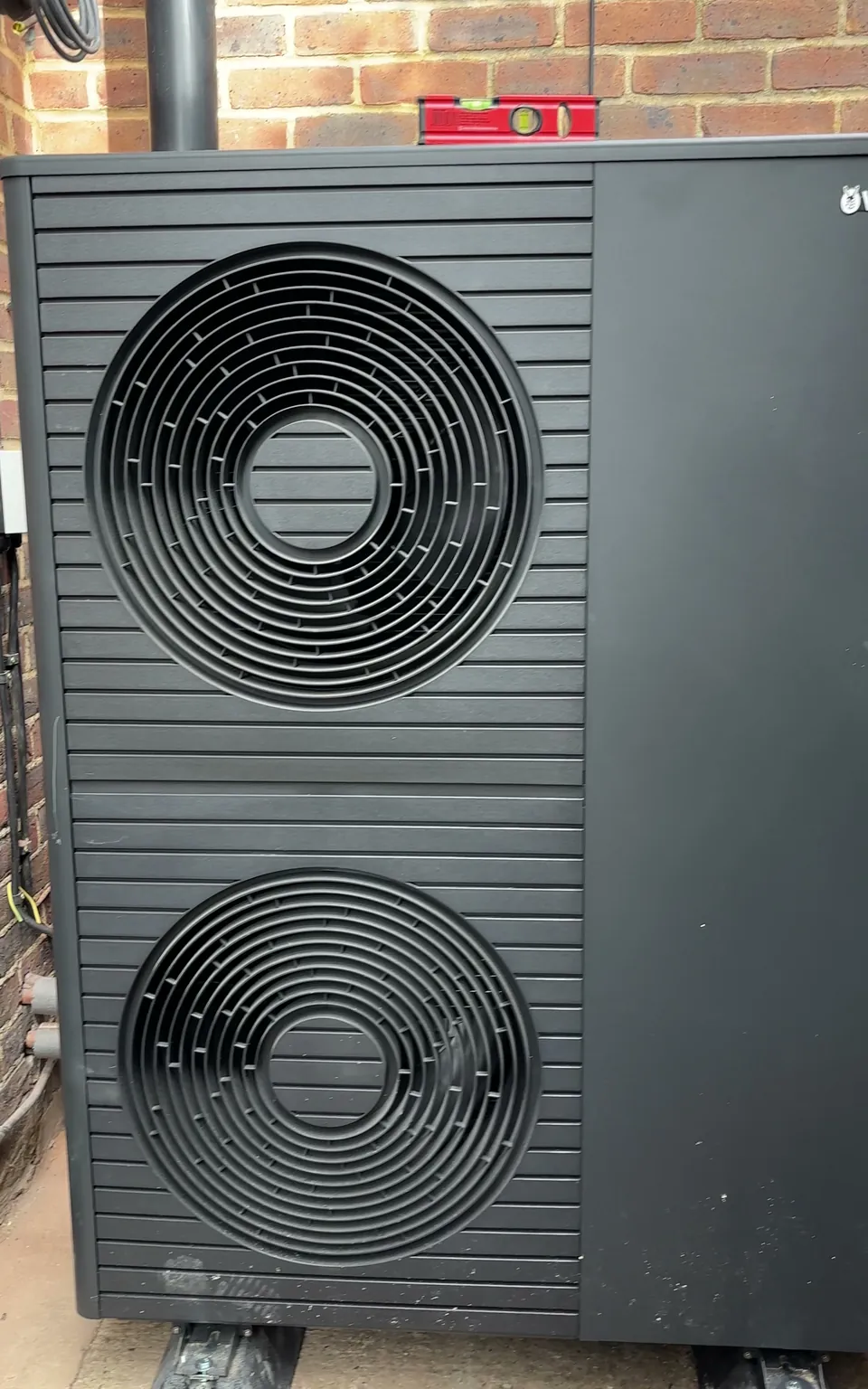 Front on: the two fans of the outdoor unit, standing clear of the wall.