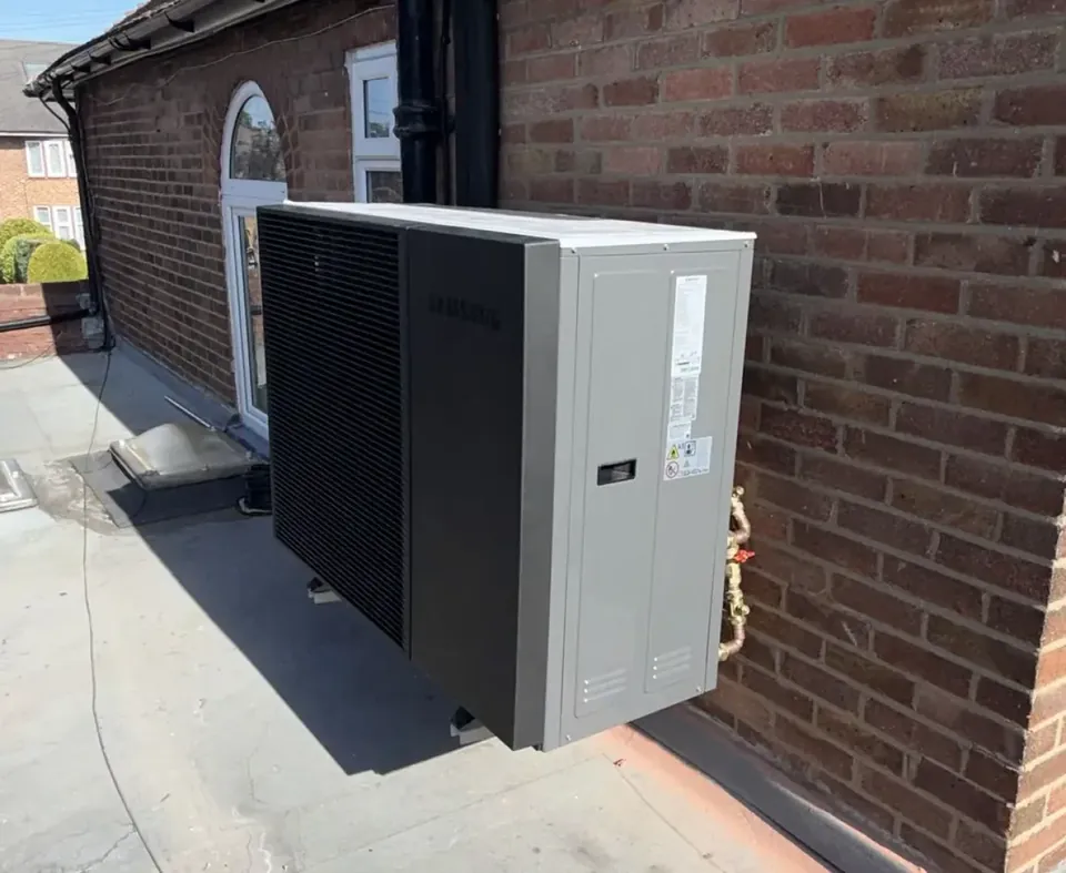 The Samsung unit on wall brackets on the side of the house, clear of the ground.