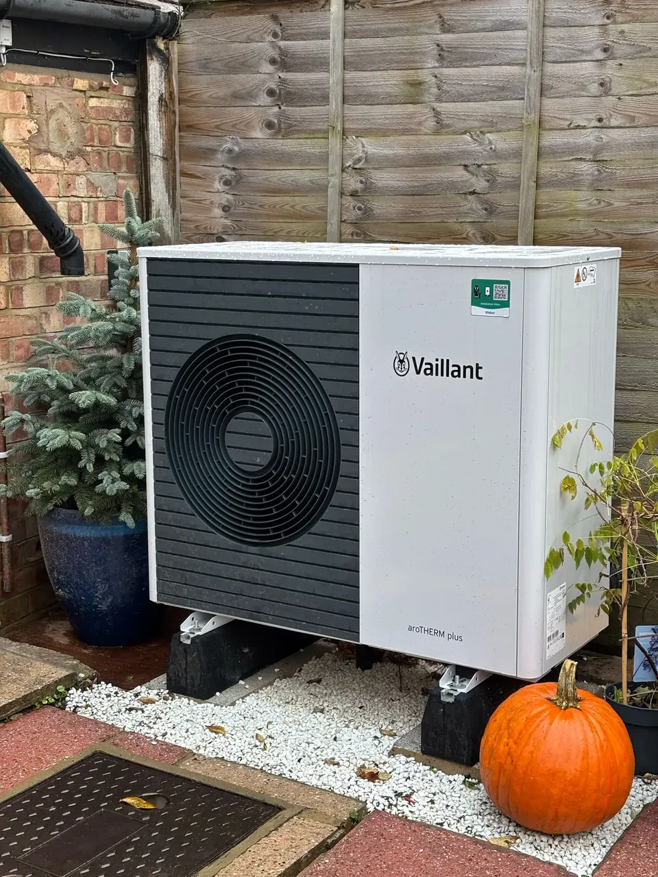 The aroTHERM plus raised on feet over a gravel bed.