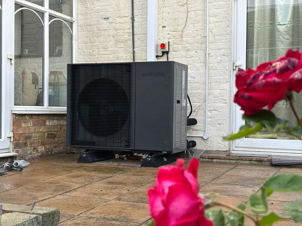 The unit at the back of the house, with the isolator on the wall.