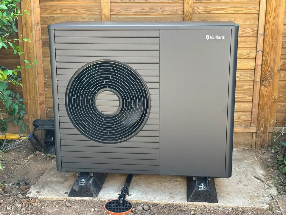 The aroTHERM plus on its poured pad against the boundary fence.