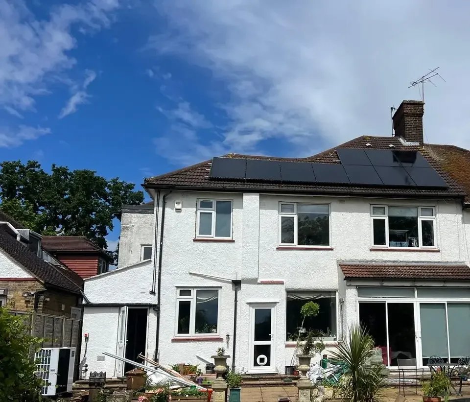 The house from the garden, with the solar panels across the rear roof.