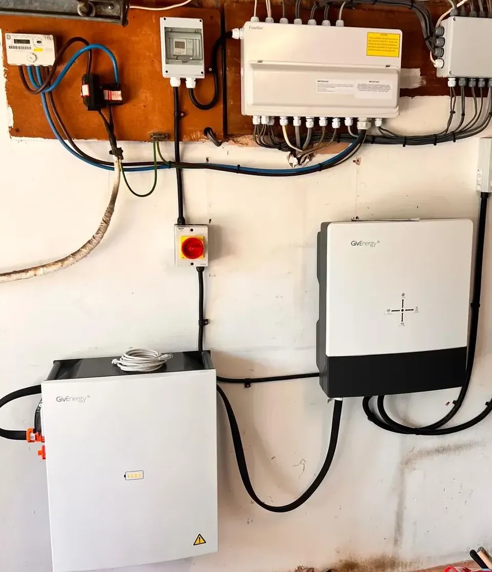 The inverter and battery on the wall indoors.