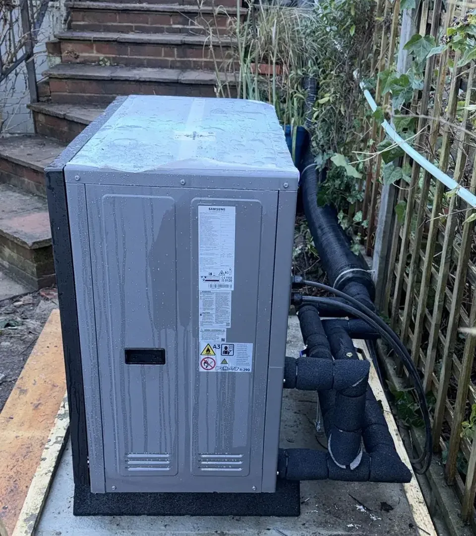The unit from the side, with the pipework insulated to the wall.
