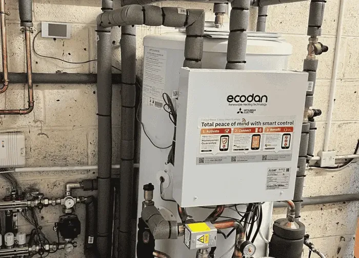 Hot water cylinder and system controls installed in a plant cupboard