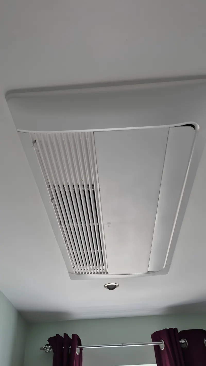 Ceiling cassette air conditioning unit recessed flush into a white ceiling